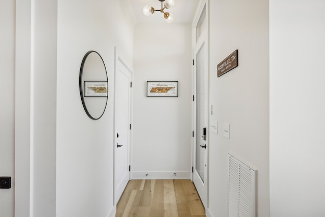 hallway with light hardwood / wood-style floors