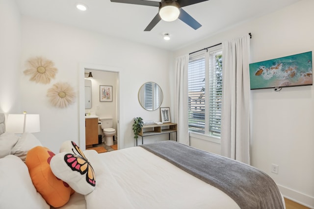 bedroom with ensuite bathroom and ceiling fan