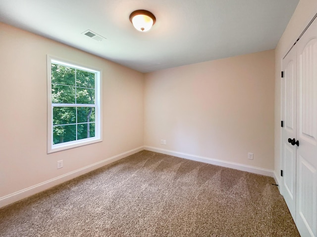 unfurnished room with carpet flooring