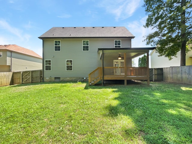 back of house with ceiling fan, a yard, and a deck