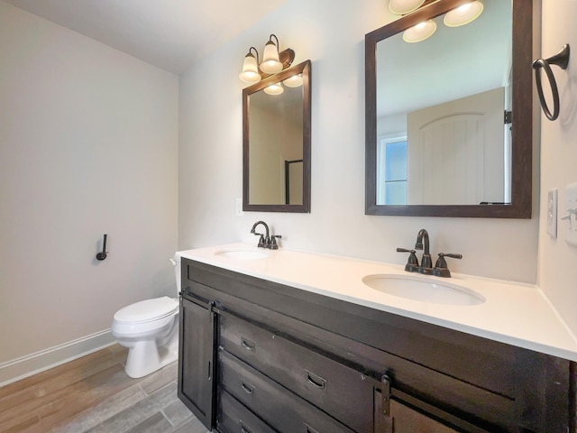 bathroom featuring hardwood / wood-style floors, vanity, and toilet