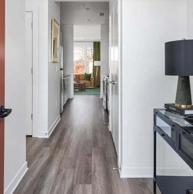 corridor featuring dark wood-type flooring