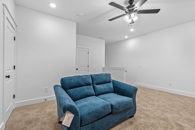 living area with recessed lighting, light carpet, and baseboards