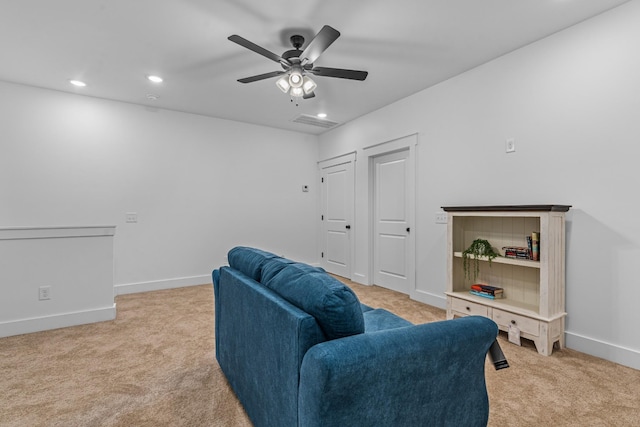 living area with light carpet, recessed lighting, and baseboards