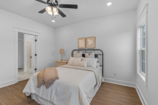 bedroom featuring ceiling fan, baseboards, wood finished floors, and recessed lighting