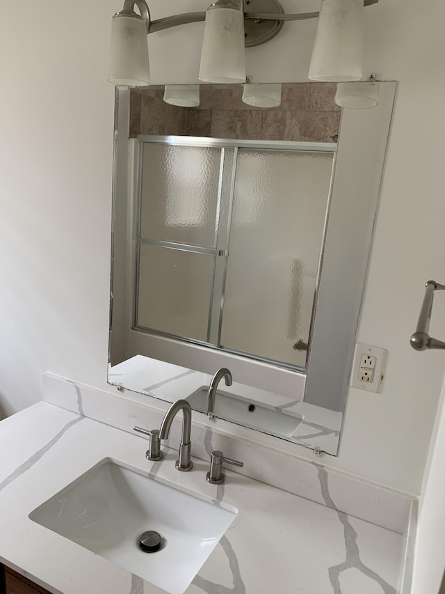 bathroom featuring walk in shower and sink