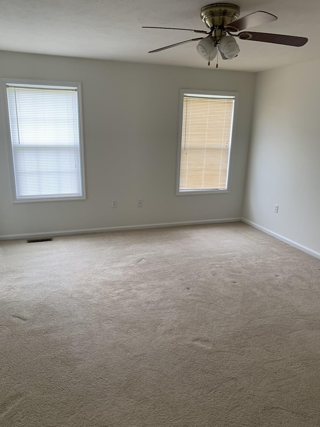 carpeted empty room with ceiling fan