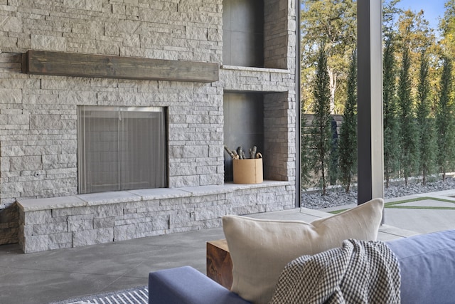 view of patio / terrace featuring an outdoor stone fireplace