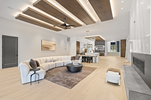 living room featuring light wood-type flooring and ceiling fan