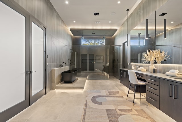 bathroom featuring vanity and shower with separate bathtub