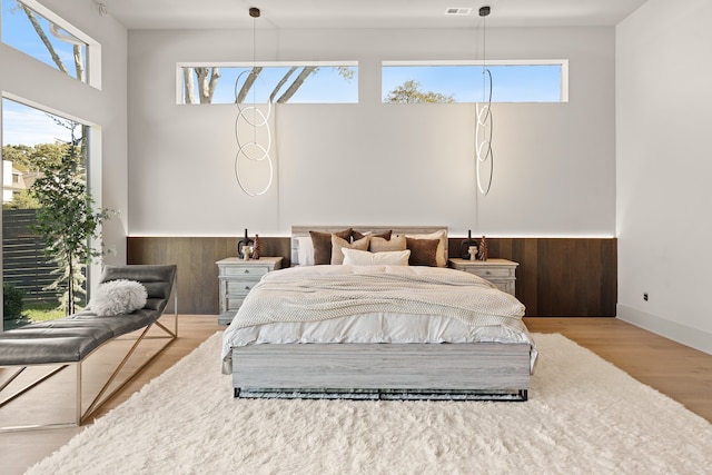 bedroom featuring hardwood / wood-style floors and multiple windows