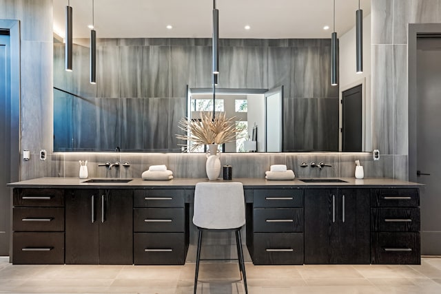 bathroom with tasteful backsplash, tile walls, and vanity