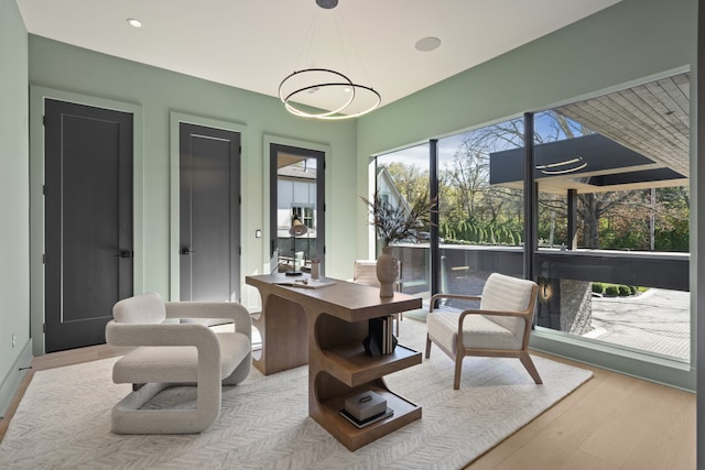 sunroom / solarium featuring an inviting chandelier