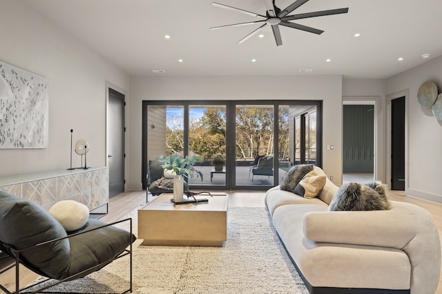 living room featuring ceiling fan and light hardwood / wood-style flooring