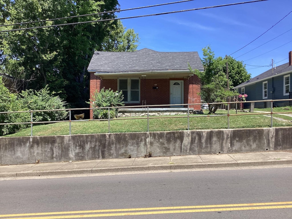 406 Natchez St, Franklin, TN 37064 - view of front of home featuring brick siding, a fenced front yard, and roof with shingles