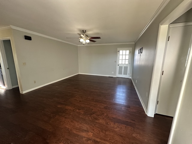 empty room with ceiling fan, dark hardwood / wood-style floors, and ornamental molding