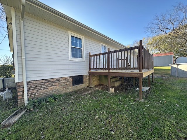 view of side of home with a lawn and a deck