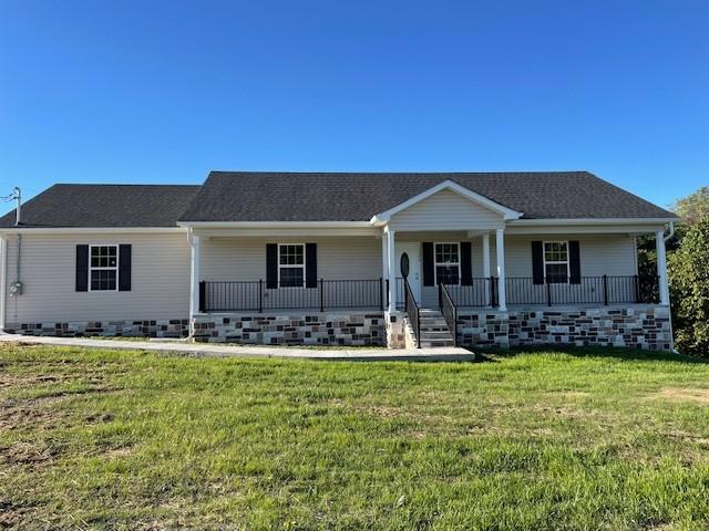 single story home featuring a front yard and covered porch