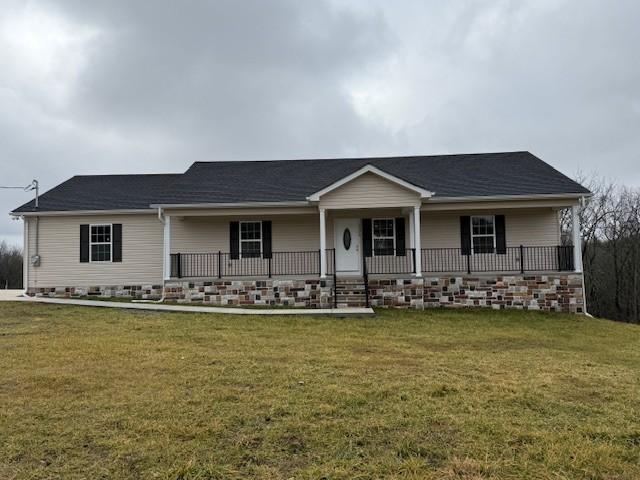 ranch-style house with a front yard and a porch
