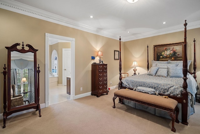 carpeted bedroom with ensuite bathroom and ornamental molding