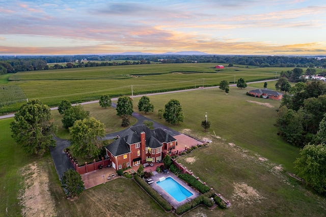 aerial view at dusk featuring a rural view