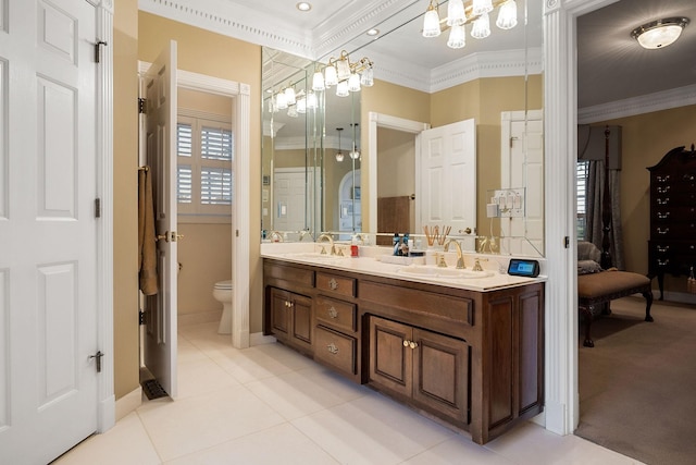 bathroom featuring vanity, crown molding, tile patterned flooring, a chandelier, and toilet