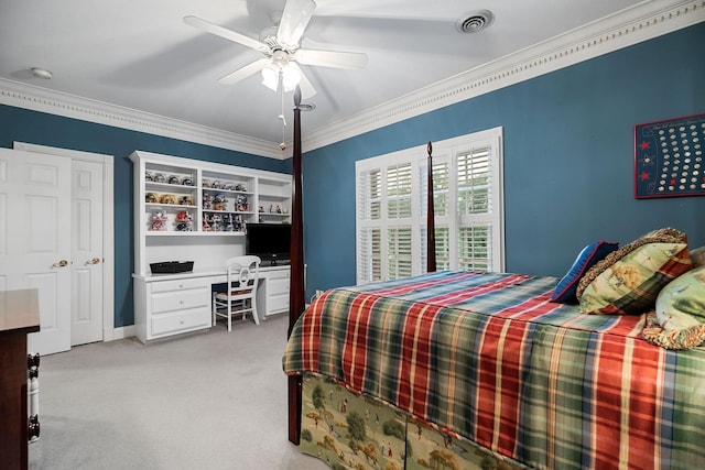 bedroom featuring ceiling fan, light colored carpet, crown molding, and a closet