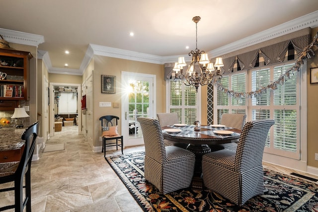 dining space featuring a wealth of natural light, crown molding, and a chandelier