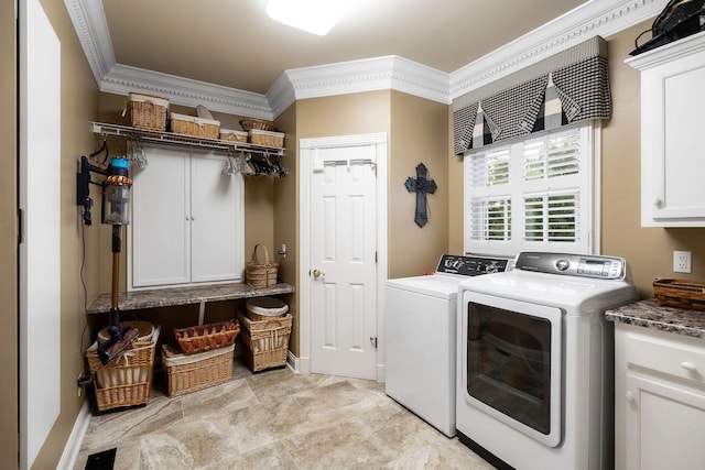 laundry room featuring cabinets, separate washer and dryer, and crown molding