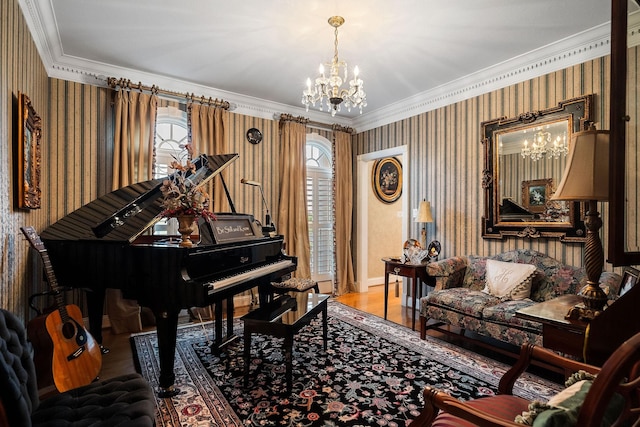 sitting room featuring hardwood / wood-style flooring, ornamental molding, and a notable chandelier