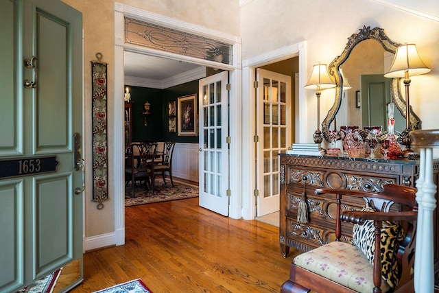 living area featuring crown molding and wood-type flooring