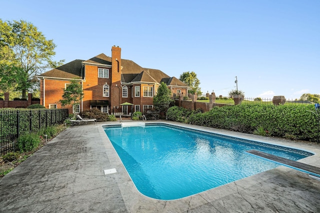 view of pool featuring a diving board