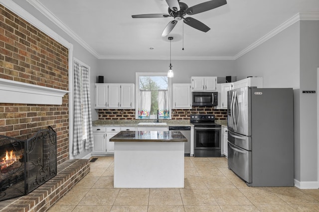 kitchen featuring white cabinetry, decorative light fixtures, stainless steel appliances, and ceiling fan