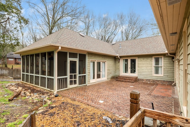 rear view of property featuring a sunroom and a patio