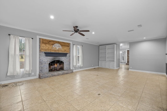 unfurnished living room with crown molding, a healthy amount of sunlight, ceiling fan, and a brick fireplace