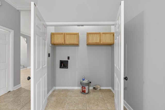 clothes washing area with washer hookup, cabinets, light tile patterned floors, and crown molding