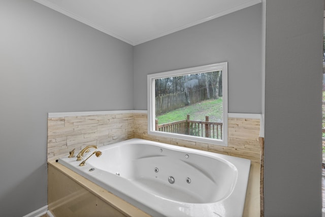 bathroom with crown molding and a bathtub