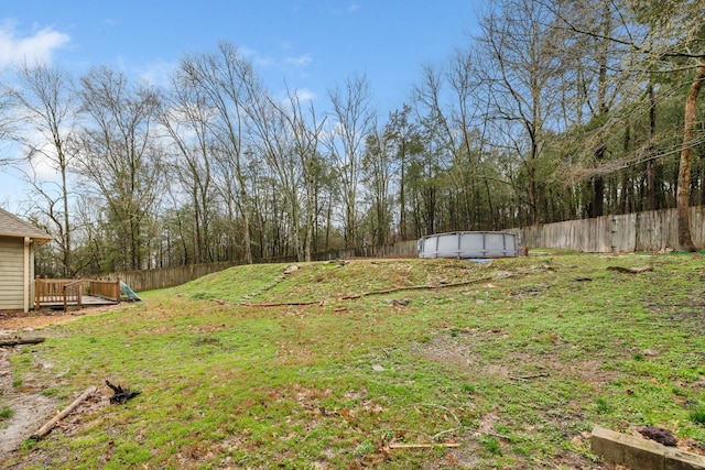 view of yard with a deck and a storage unit