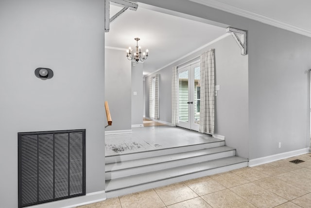 entryway with french doors, a notable chandelier, light tile patterned flooring, and ornamental molding