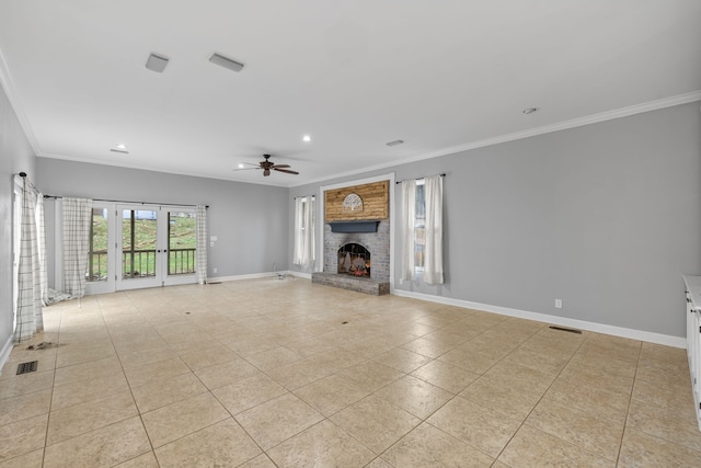 unfurnished living room featuring crown molding, ceiling fan, light tile patterned floors, and a brick fireplace