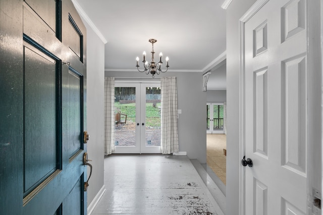 entryway with crown molding, a notable chandelier, and french doors