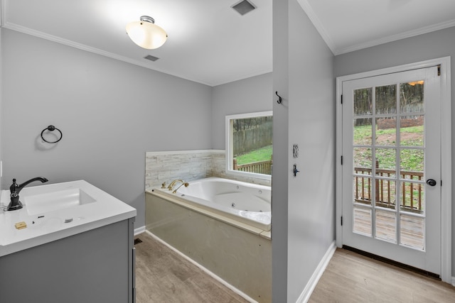 bathroom with vanity, ornamental molding, wood-type flooring, and a washtub