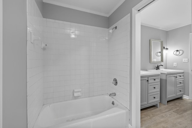 bathroom featuring ornamental molding, vanity, tiled shower / bath combo, and hardwood / wood-style floors