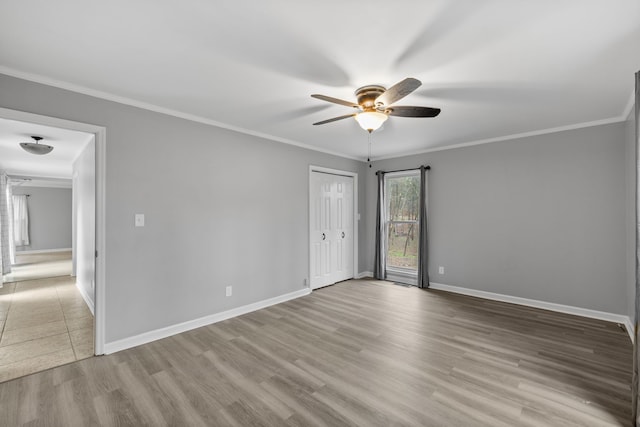 spare room featuring ceiling fan, hardwood / wood-style flooring, and ornamental molding