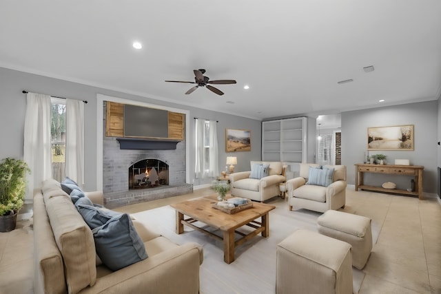 living room with crown molding, a brick fireplace, light tile patterned flooring, built in features, and ceiling fan