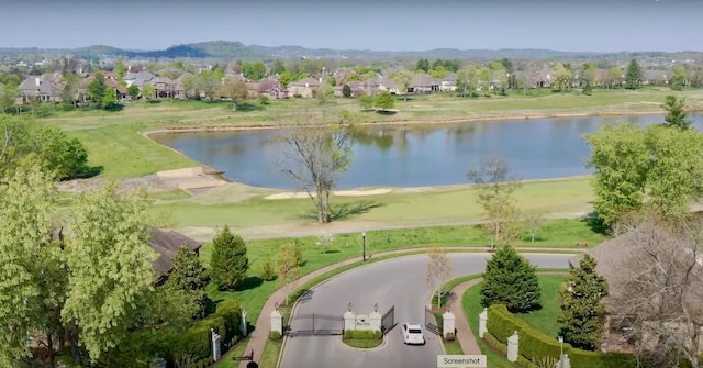 drone / aerial view with a water view and a residential view