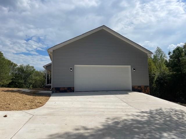 view of home's exterior featuring driveway and a garage