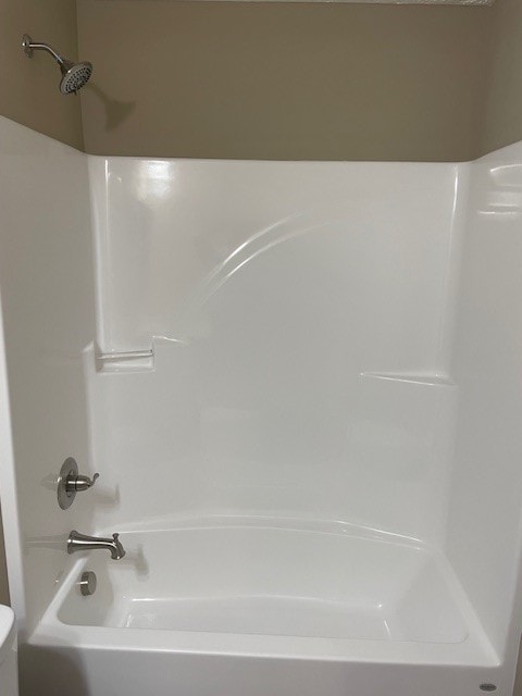 bathroom with toilet and shower / bath combination