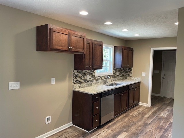 kitchen featuring sink, dark wood-type flooring, dishwasher, and dark brown cabinetry