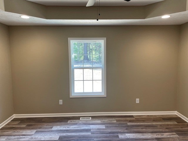 spare room featuring ceiling fan and dark hardwood / wood-style floors